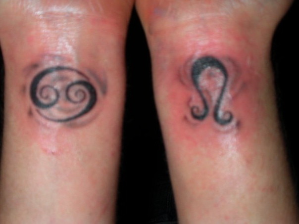 Black Ink Cancer And Leo Zodiac Sign Tattoo On Both Wrist