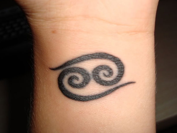 Black Ink Cancer Zodiac Sign Tattoo On Wrist
