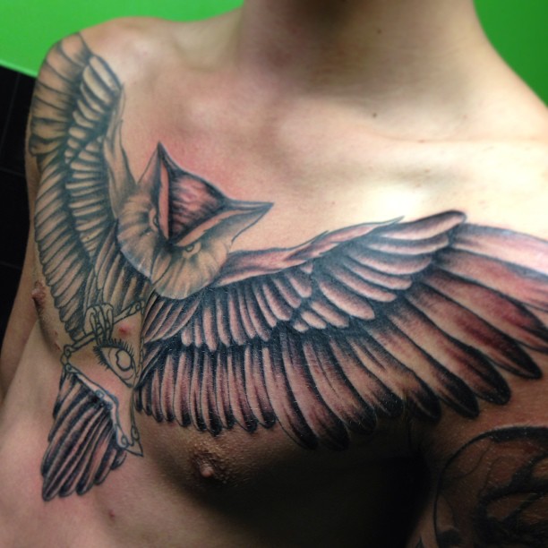 Black Ink Flying Owl With Illuminati Eye Tattoo On Man Chest