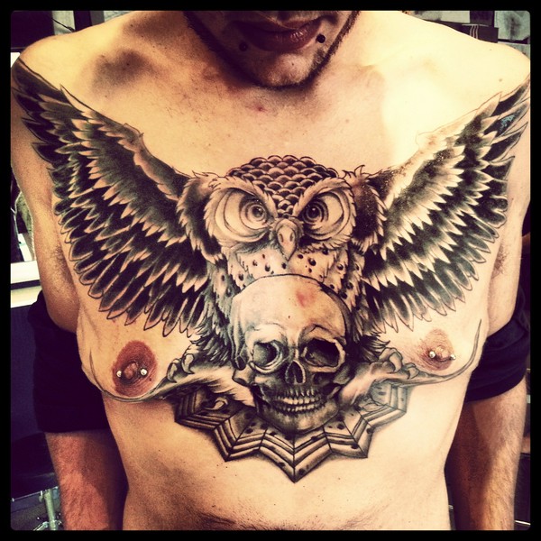Black Ink Flying Owl With Skull Tattoo On Man Chest By Meghan