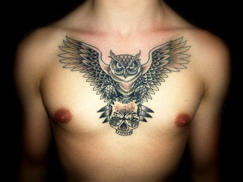Black Ink Flying Owl With Skull Tattoo On Man Chest
