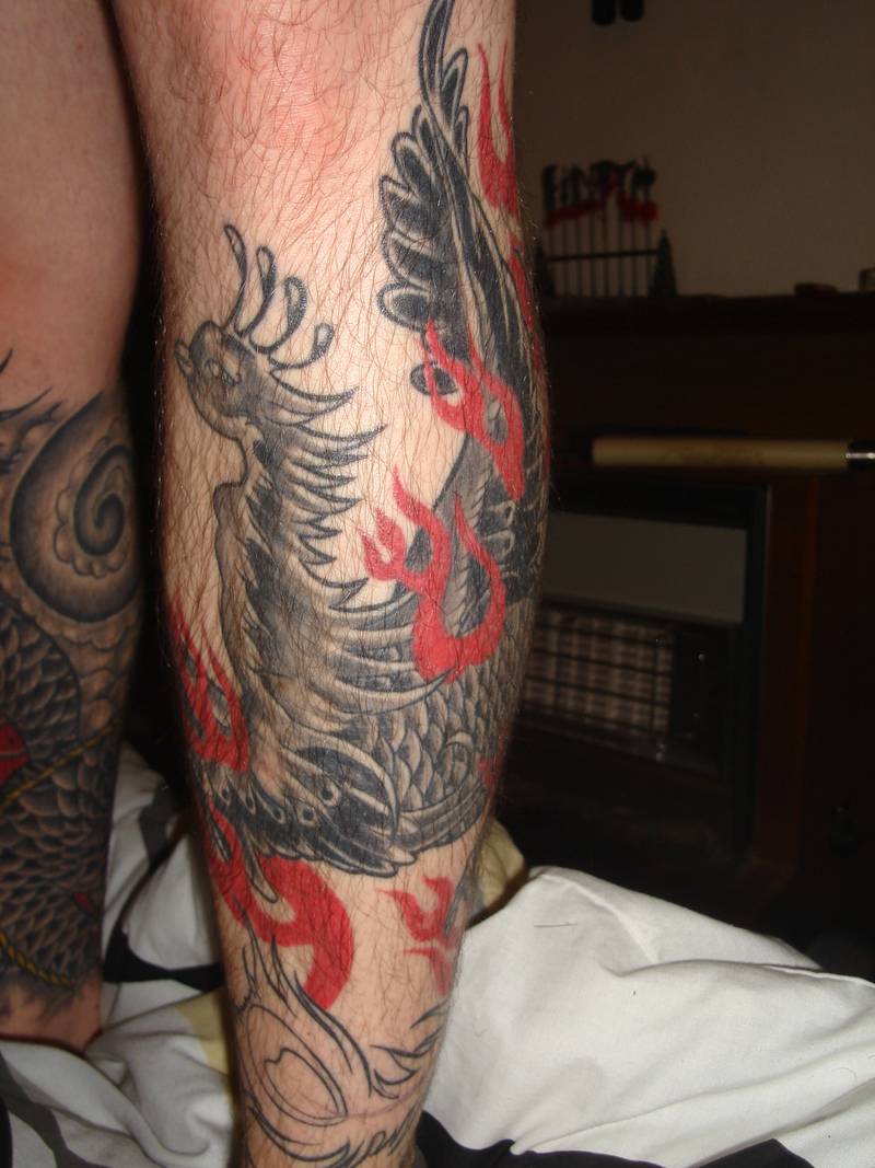 Black Ink Flying Phoenix Tattoo On Leg
