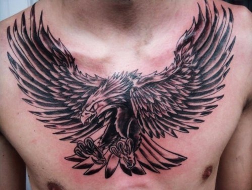 Black Ink Flying Phoenix Tattoo On Man Chest