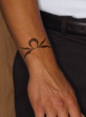 Black Ink Libra Zodiac Sign Tattoo On Right Upper Wrist