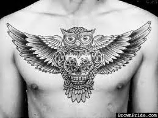 Black Ink Owl With Sugar Skull Tattoo On Man Chest