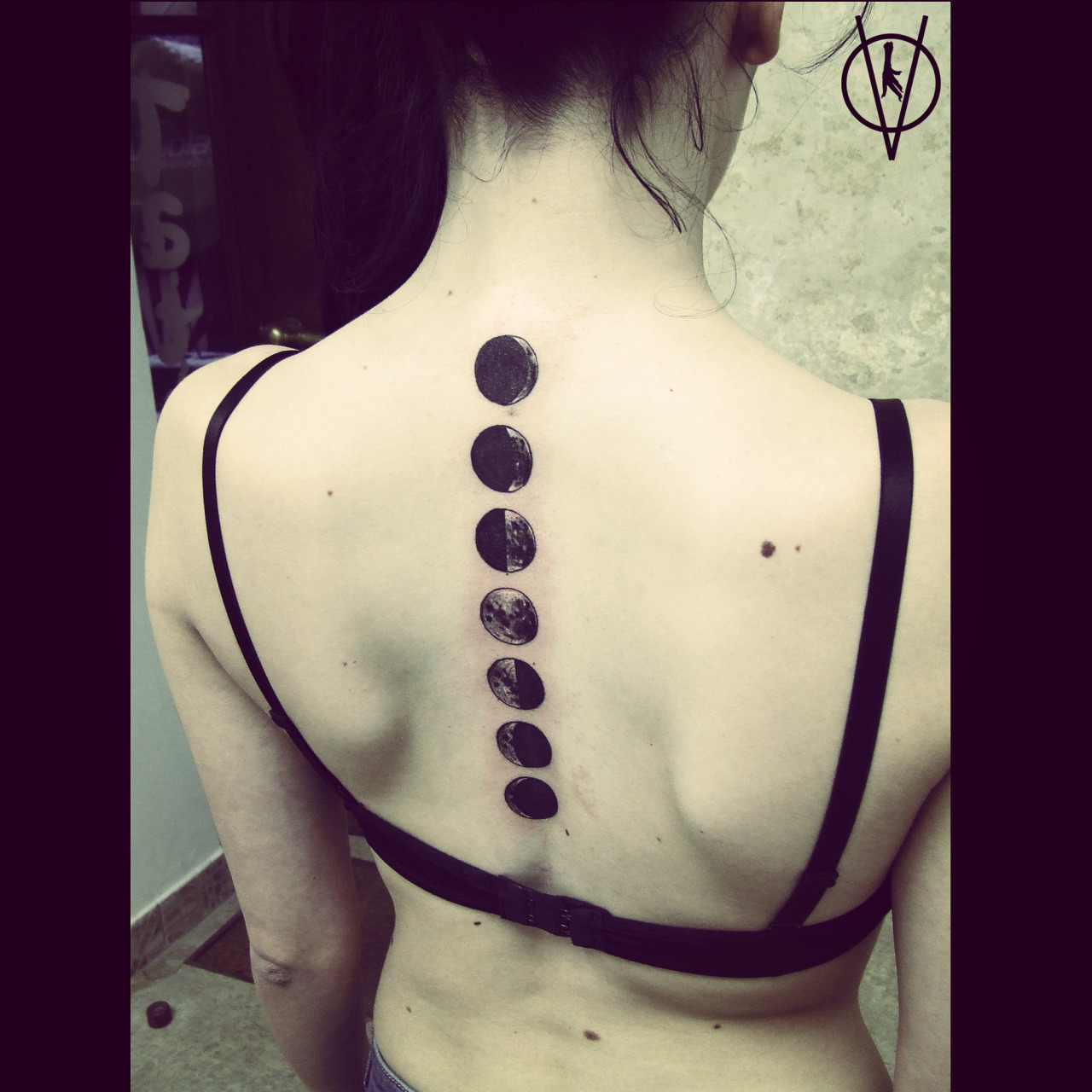 Black Ink Phases Of The Moon Tattoo On G irl Spine.