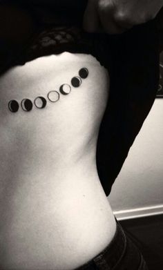 Black Ink Phases Of The Moon Tattoo On Girl Side Rib