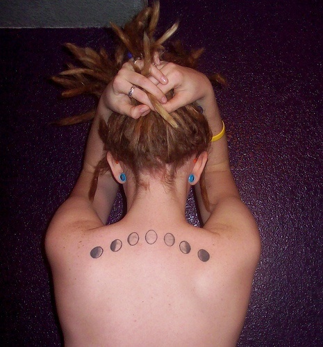 Black Ink Phases Of The Moon Tattoo On Girl Upper Back