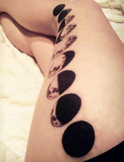 Black Ink Phases Of The Moon Tattoo On Left Thigh