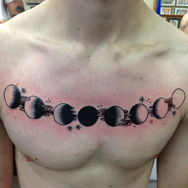 Black Ink Phases Of The Moon Tattoo On Man Chest