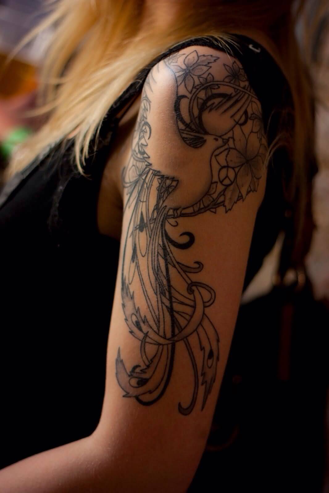 Black Ink Phoenix Tattoo On Girl Left Upper Arm