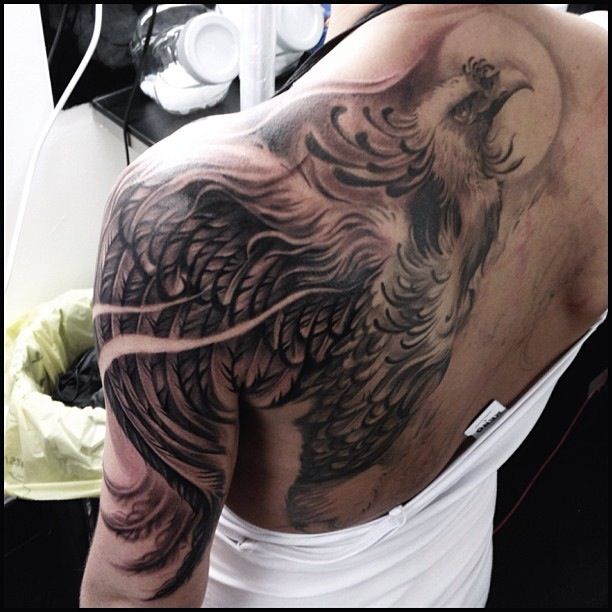 Black Ink Phoenix Tattoo On Left Back Shoulder