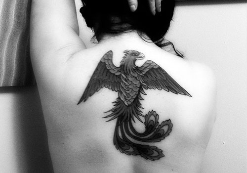Black Ink Phoenix Tattoo On Upper Back