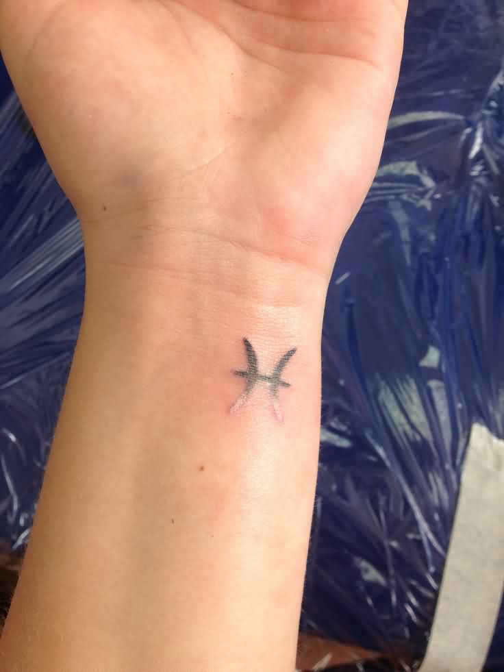 Black Ink Pisces Zodiac Sign Tattoo On Left Wrist