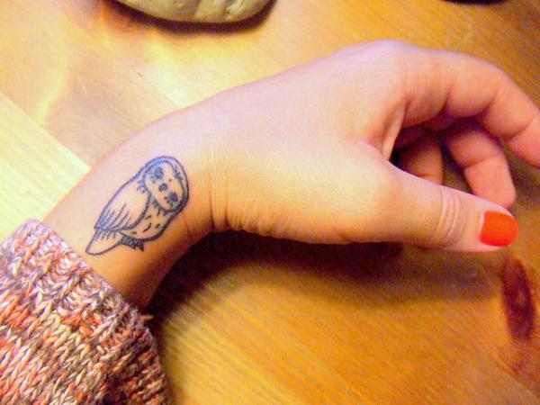 Black Ink Small Owl Tattoo On Girl Left Side Wrist
