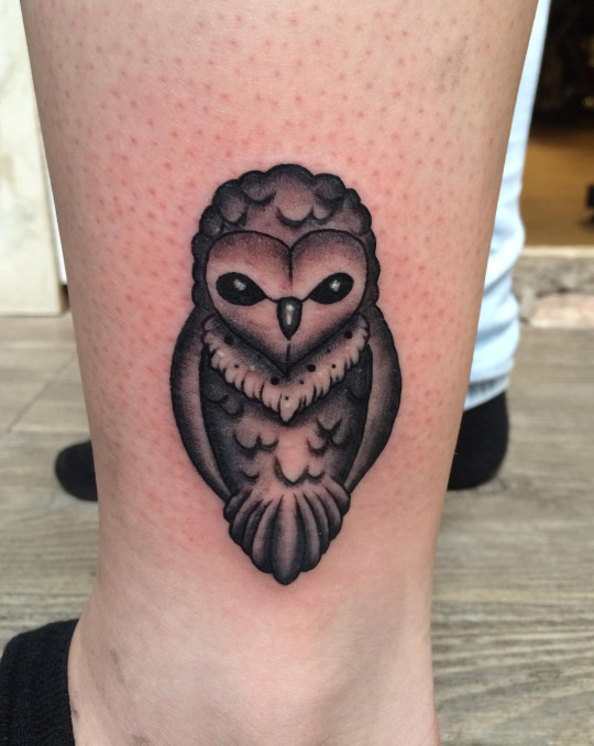 Black Ink Small Owl Tattoo On Left Leg