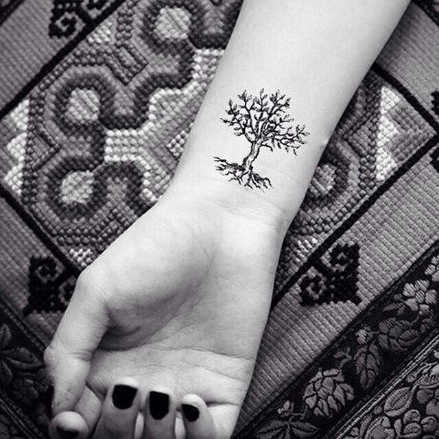 Black Ink Small Tree Of Life Tattoo On Right Wrist