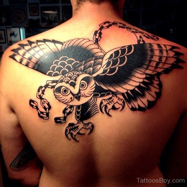 Black Ink Traditional Flying Owl Tattoo On Man Upper Back