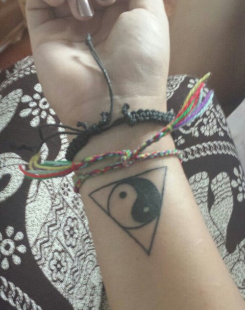 Black Ink Yin Yang In Upside Down Triangle Tattoo On Girl Right Wrist