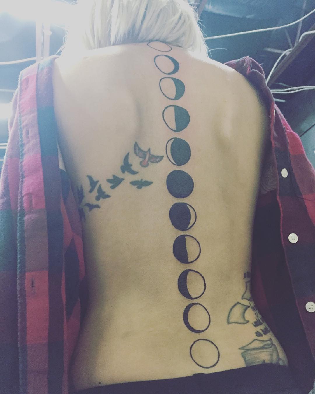Black Phases Of The Moon With Flying Bird Tattoo On Girl Spine