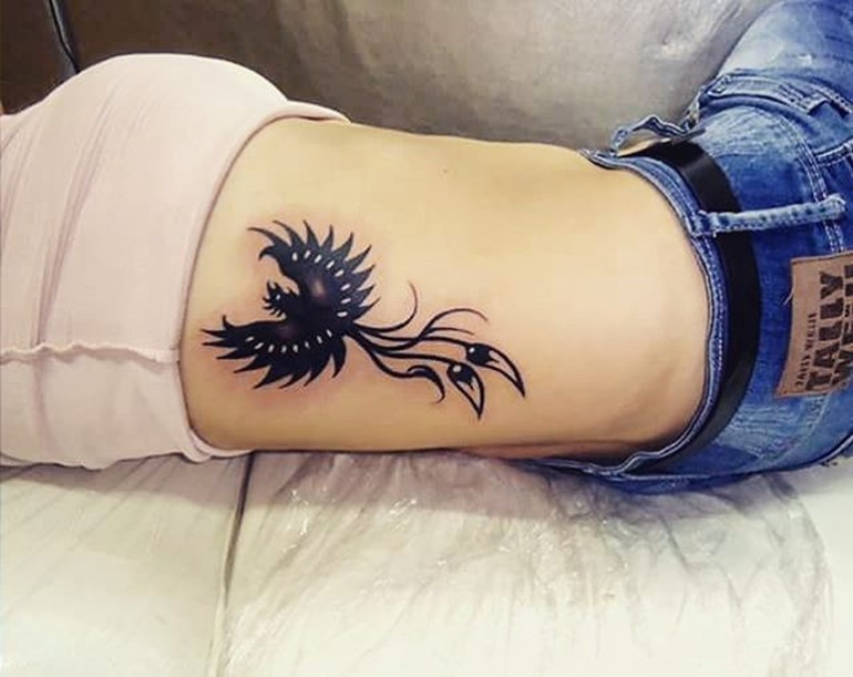 Black Phoenix Tattoo On Girl Right Side Rib