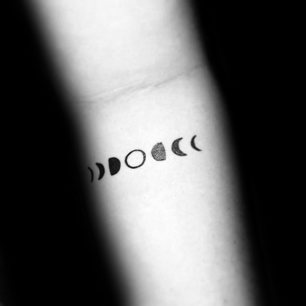 Black Small Phases Of The Moon Tattoo On Forearm