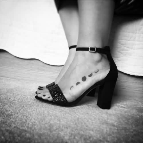 Black Small Phases Of The Moon Tattoo On Girl Left Foot