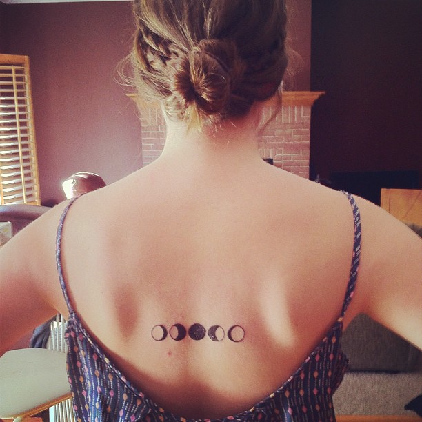 Black Small Phases Of The Moon Tattoo On Girl Upper Back