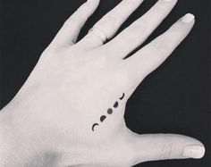 Black Small Phases Of The Moon Tattoo On Left Hand By Misssfaith