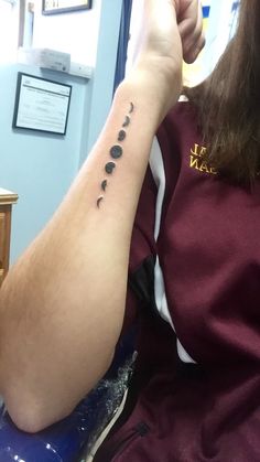 Black Small Phases Of The Moon Tattoo On Right Forearm