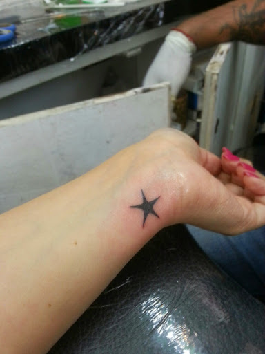 Black Star Tattoo On Girl Left Wrist