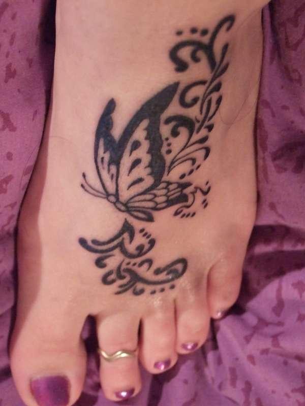 Black Tribal Butterfly Girl Left Foot Tattoo