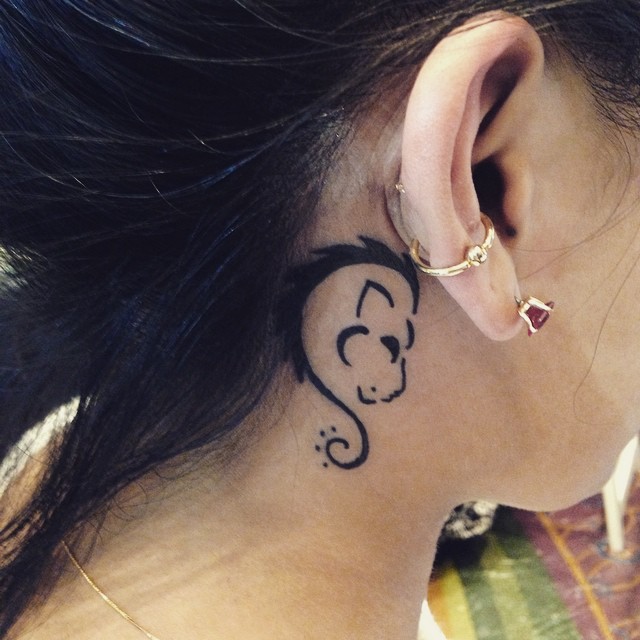 Black Tribal Leo Zodiac Sign Tattoo On Girl Right Behind The Ear