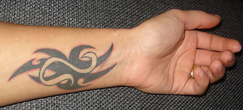 Black Tribal Leo Zodiac Sign Tattoo On Left Wrist