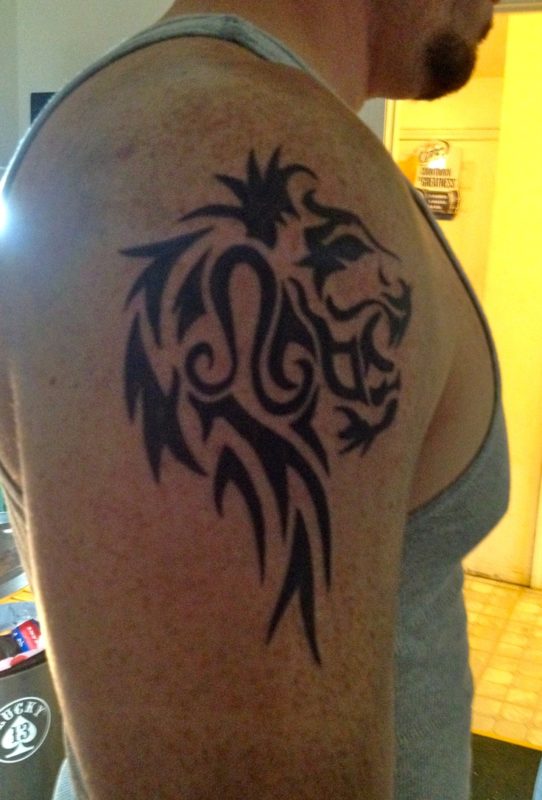 Black Tribal Leo Zodiac Sign Tattoo On Man Right Shoulder
