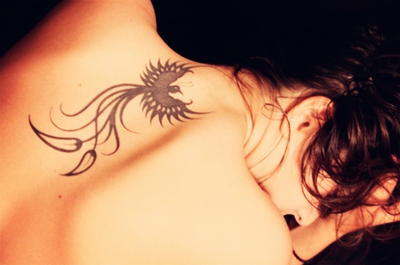 Black Tribal Phoenix Tattoo On Girl Upper Back