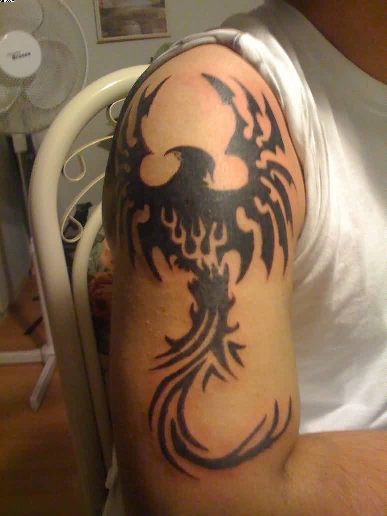 Black Tribal Phoenix Tattoo On Man Right Shoulder