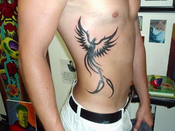 Black Tribal Phoenix Tattoo On Man Right Side Rib
