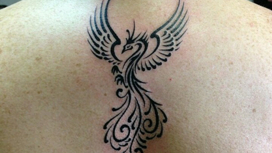 Black Tribal Rising Phoenix From The Ashes Tattoo Design For Upper Back