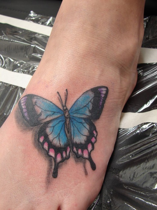 Blue Butterfly Tattoo On Left Foot