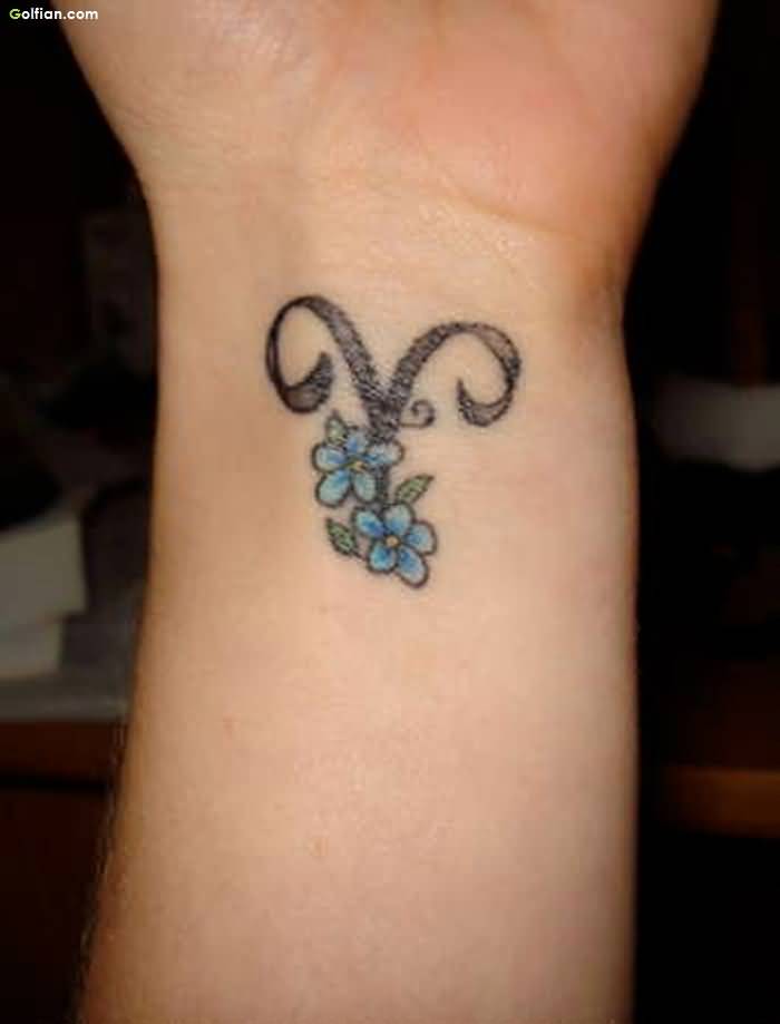 Blue Flowers With Aries Zodiac Sign Tattoo On Left Wrist