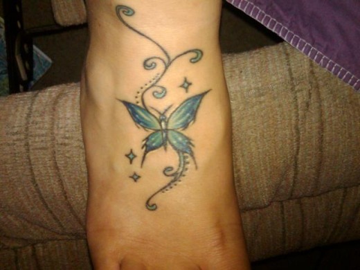 Blue Ink Butterfly Right Foot Tattoo