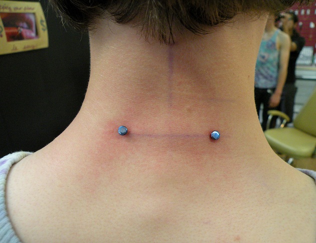 Blue Microdermal Back Neck Piercing