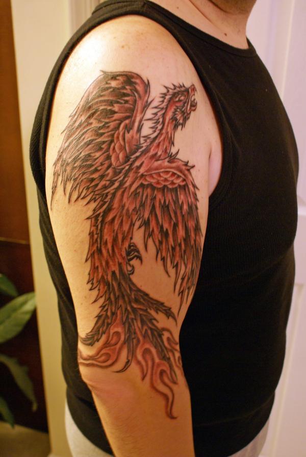 Classic Black Ink Phoenix Tattoo On Man Right Upper Arm By Doug