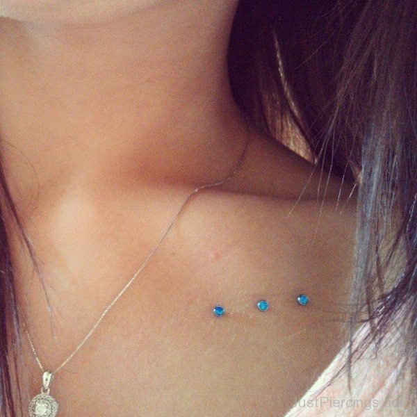 Clavicle Piercing With Blue Dermals