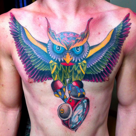 Colorful Flying Owl With Clock Tattoo On Man Chest