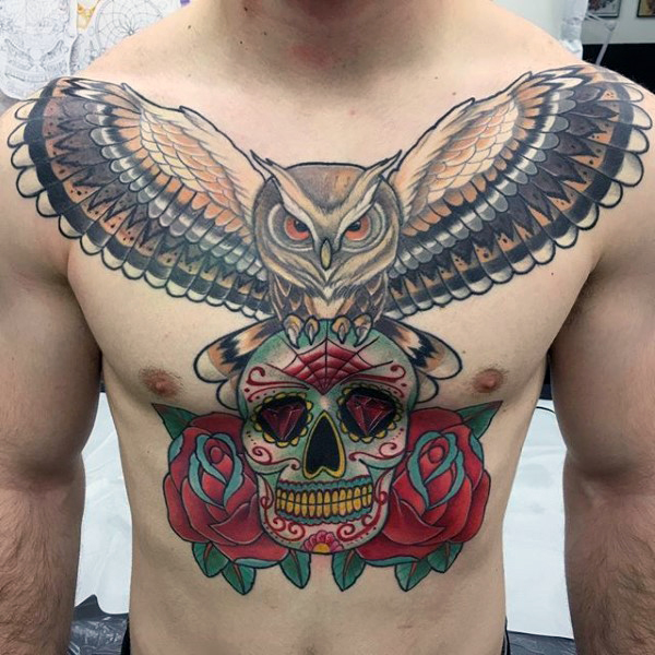 Colorful Flying Owl With Sugar Skull And Roses Tattoo On Man Chest