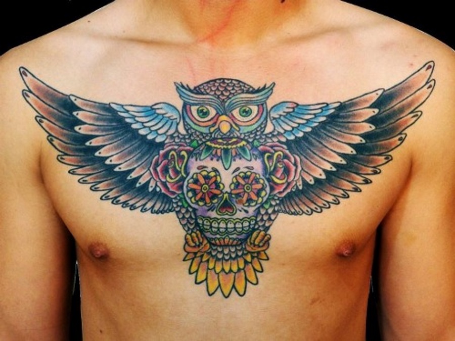 Colorful Flying Owl With Sugar Skull Tattoo On Man Chest