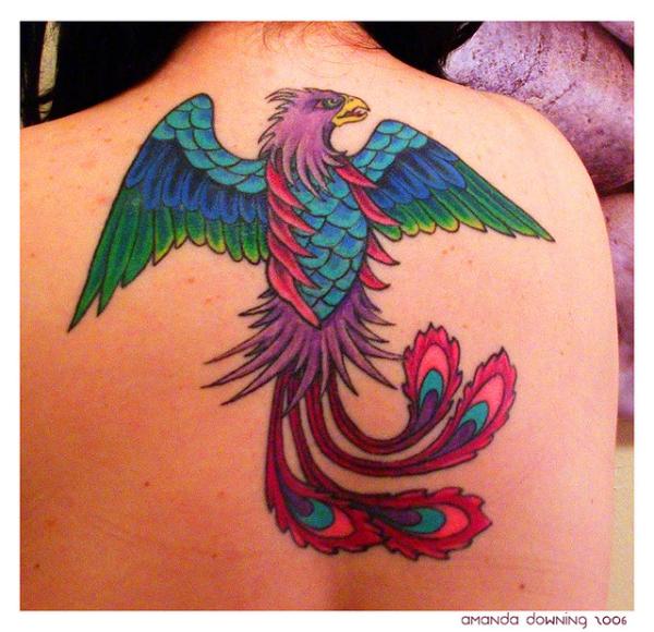 Colorful Flying Phoenix Bird Tattoo On Upper Back