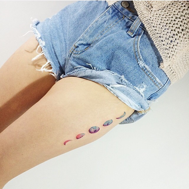 Colorful Phases Of The Moon Tattoo On Girl Left Thigh